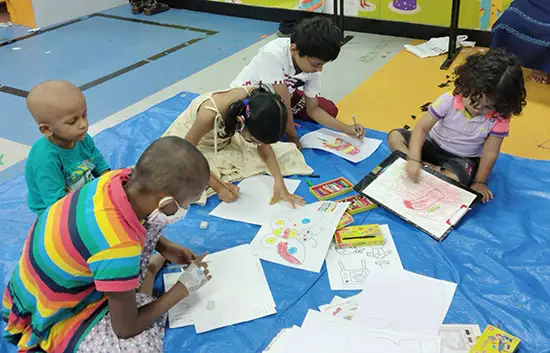 Children paint butterflies at the art workshop