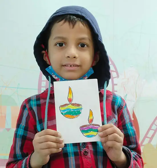 Kid showing Panati greeting card at art workshop for Diwali artefacts