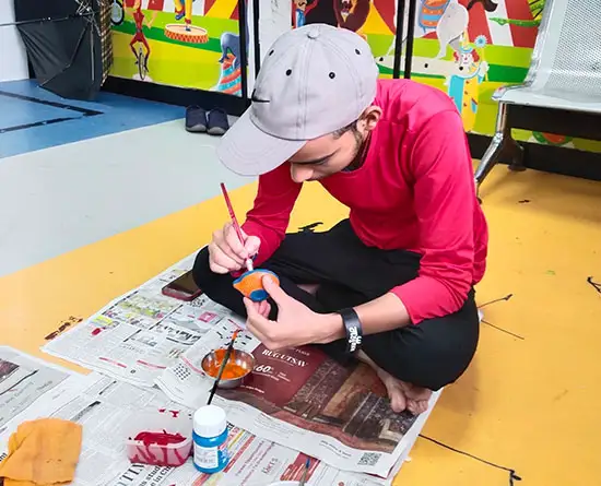 Children painting diya at art workshop for kids at TMC, Mumbai