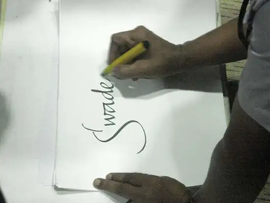 Prof. Babu Udupi demonstrating English calligraphy