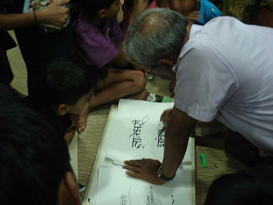 Prof. Babu Udupi demonstrating calligraphy