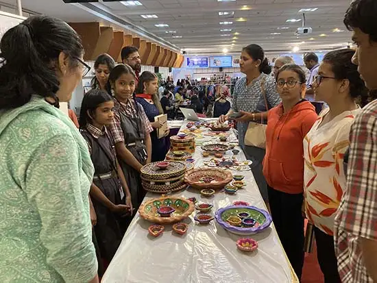 Students interact with visitors at the exhibition