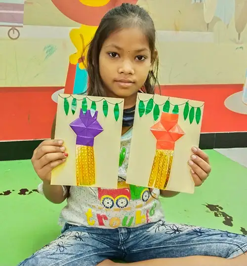 Girl showing greeting card made for Diwali