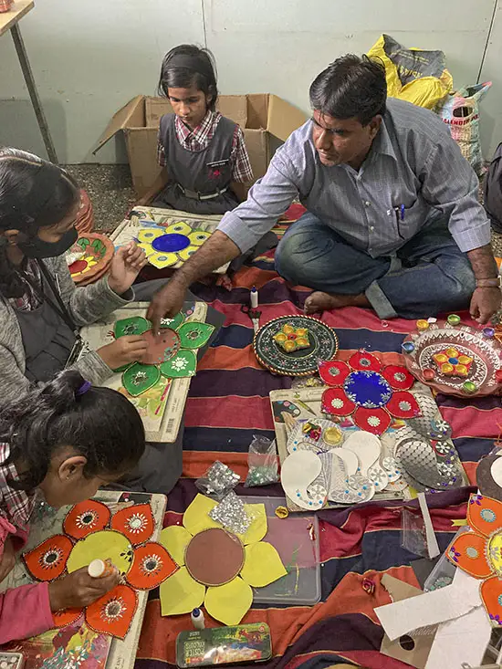 Art and craft teacher Shri. M. M. Maniyar guides the students to create Diwali artefacts