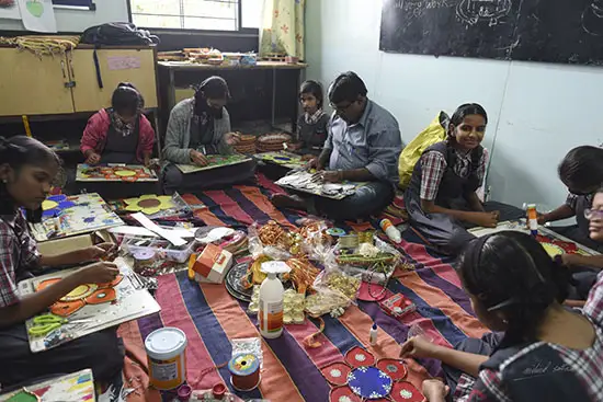 Students from School for Hearing and Speech Impaired, paint diyas