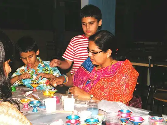Painting and decorating diyas by participants