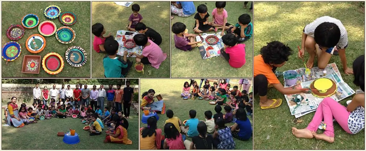 children paint earthen pots on Holi festival