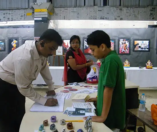 participant writing in visitors book at Balgandharav Kaladalan Pune