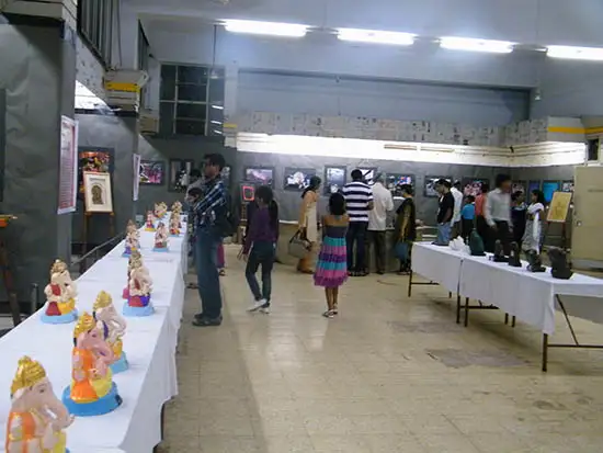 people visiting Balgandharav Kaladalan and viewing ganesh idols at exhibition