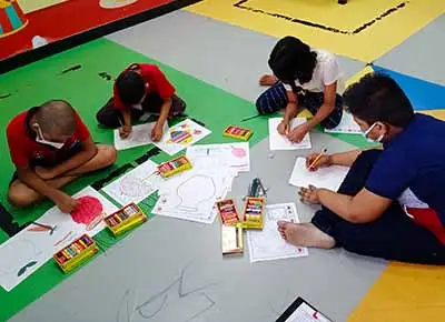 Children paints flower vase at art workshop for children on 2 June 2022
