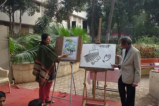 S. D. (Shi Da) Phadnis and Chitra Vaidya giving finishing touches to their artworks. 