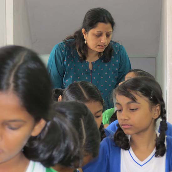 Artist Chitra Vaidya looking at students