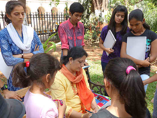 Chitra Vaidya demonstrating in workshop with chidren