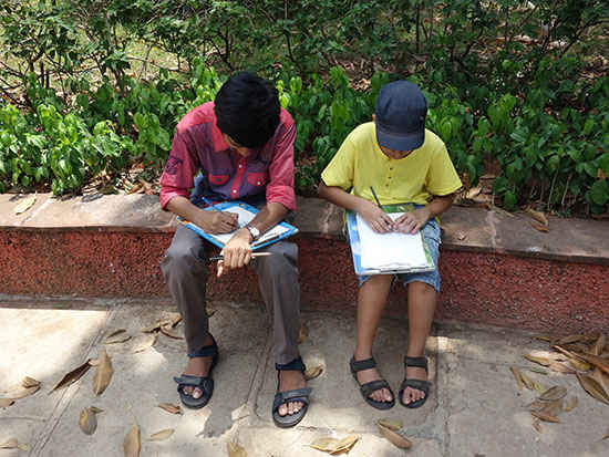 Boys enjoying painting at art workshop 